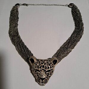 Jaguar leopard head pendant on a multichain silver tone necklace